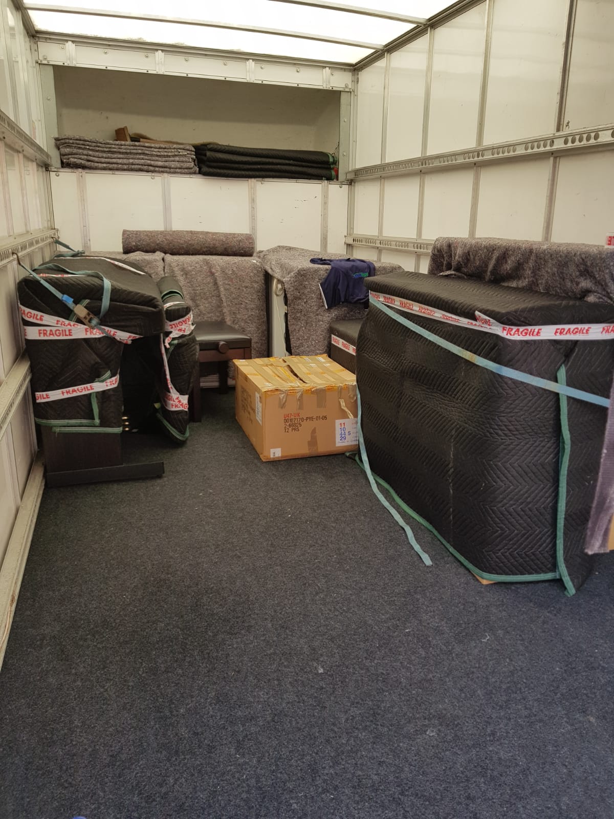 Sofas and items secured with fragile straps in the van