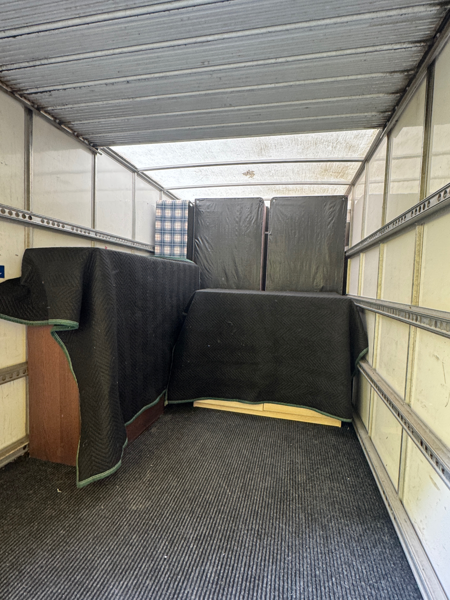 Furniture protected with moving blankets inside the van